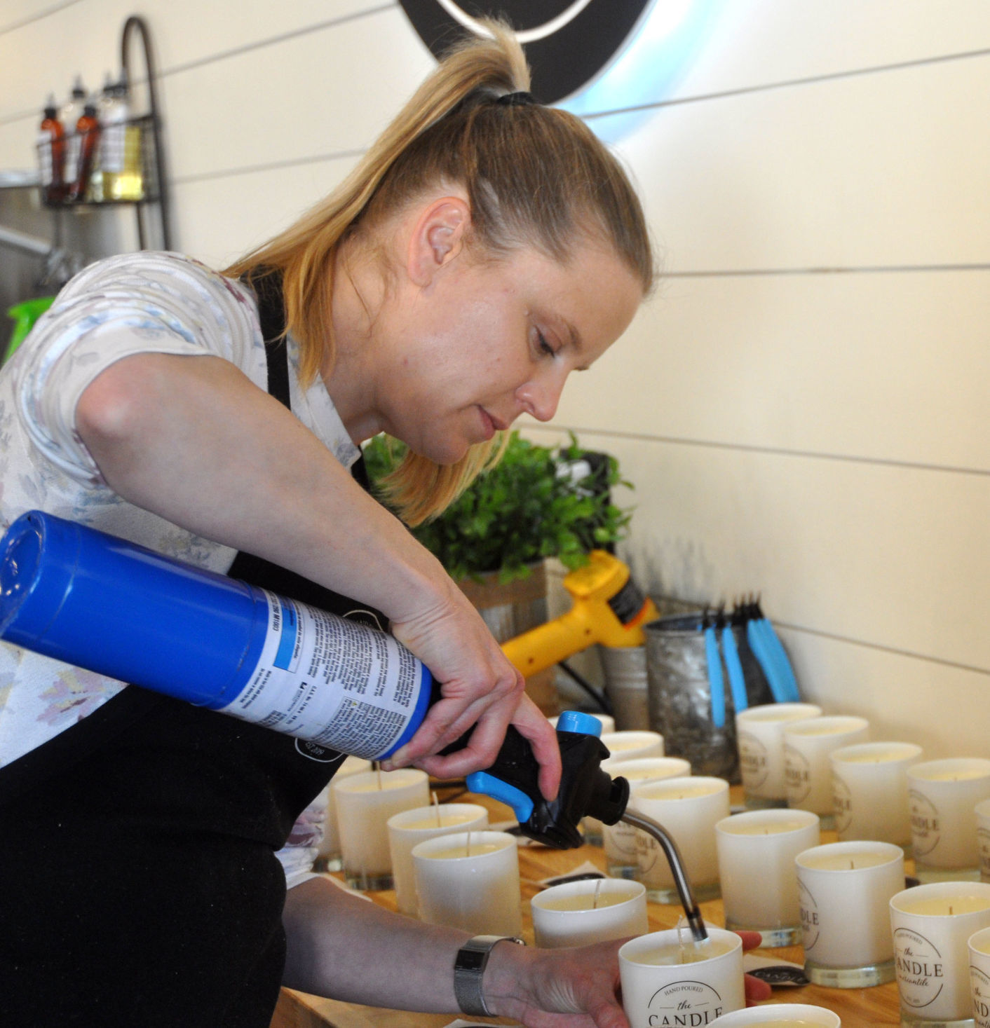 Natalie Sliwinksi, employee at the The Candle Mercantile, 870 W. Main St., prepares some candles
